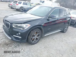 2017 BMW X1 sDrive28i with VIN WBXHU7C36HP924874, listed as a IAAI auction lot 41368396 with 113,443 mi miles. Bid and sale history available at carsss.com. Image 2.