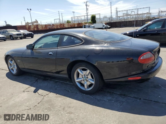1997 Jaguar XK with VIN SAJGX5740VC014035, listed as a Copart auction lot 53066215 with 140,692 mi miles and Salvage Title. Bid and sale history available at DreamBid. Image 2.