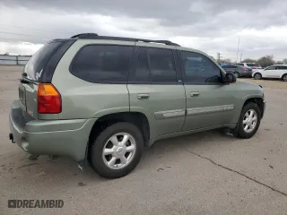 2004 GMC Envoy SLE with VIN 1GKDT13S242371123, listed as a Copart auction lot 50676215 with 156,980 mi miles and Salvage Title. Bid and sale history available at carsss.com. Image 3.