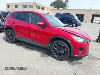 2016 Mazda CX-5 Grand Touring z VIN JM3KE2DYXG0865095, wystawiony jako IAAI lot #41852186 z przebiegiem 147 534 mil mil oraz . Historia ofert i sprzedaży dostępna na DreamBid. Obrazek 1.