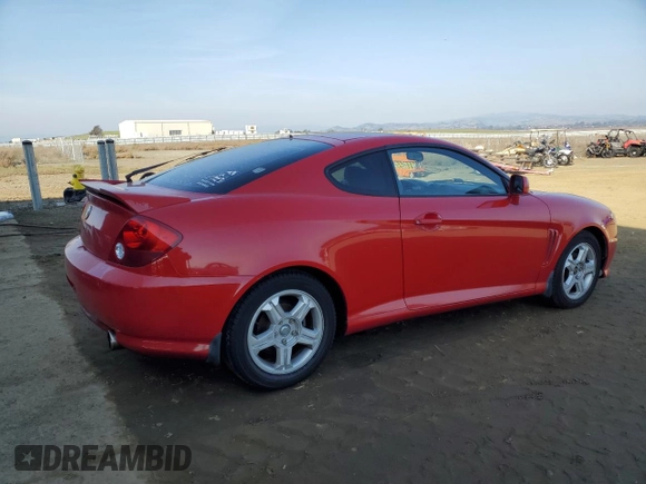2003 Hyundai Tiburon GT z VIN KMHHN65F63U060104, wystawiony jako Copart lot #84560184 z przebiegiem 160 120 mil mil oraz Czysty tytuł • Clean title. Historia ofert i sprzedaży dostępna na DreamBid. Obrazek 3.
