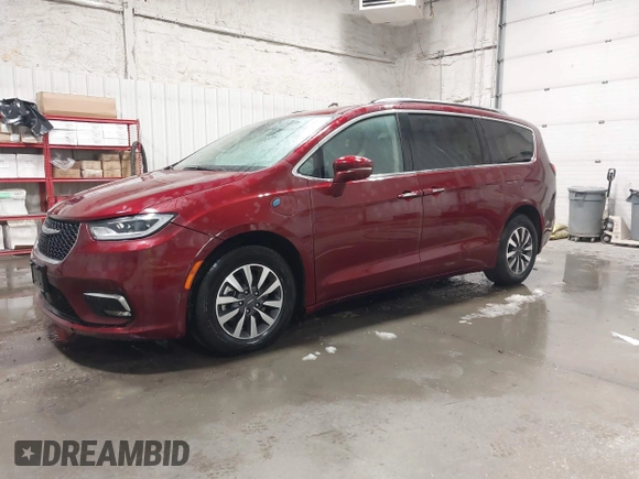 2021 Chrysler Pacifica Hybrid Touring L with VIN 2C4RC1L71MR581260, listed as a IAAI auction lot 42014401 with 68,719 mi miles and . Bid and sale history available at DreamBid. Image 2.