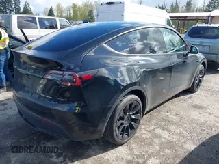 2022 Tesla Model Y Long Range with VIN 7SAYGDEEXNF459834, listed as a IAAI auction lot 42004576 with 56,175 mi miles and . Bid and sale history available at carsss.com. Image 4.