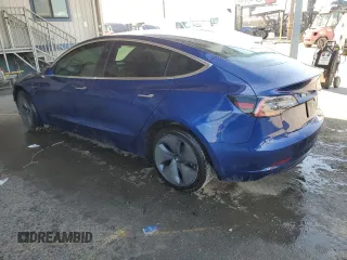 2020 Tesla Model 3 Standard Range Plus with VIN 5YJ3E1EA7LF705907, listed as a Copart auction lot 48765145 with 104,479 mi miles and Salvage Title. Bid and sale history available at DreamBid. Image 2.