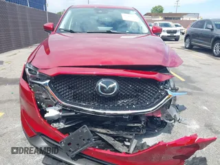 2021 Mazda CX-5 Grand Touring with VIN JM3KFADM6M1373111, listed as a IAAI auction lot 42784431 with 14,374 mi miles and . Bid and sale history available at DreamBid. Image 12.
