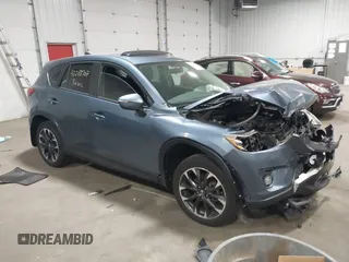 2016 Mazda CX-5 Grand Touring z VIN JM3KE2DY2G0604124, wystawiony jako IAAI lot #42288707 z przebiegiem 141 996 mil mil oraz . Historia ofert i sprzedaży dostępna na DreamBid. Obrazek 1.