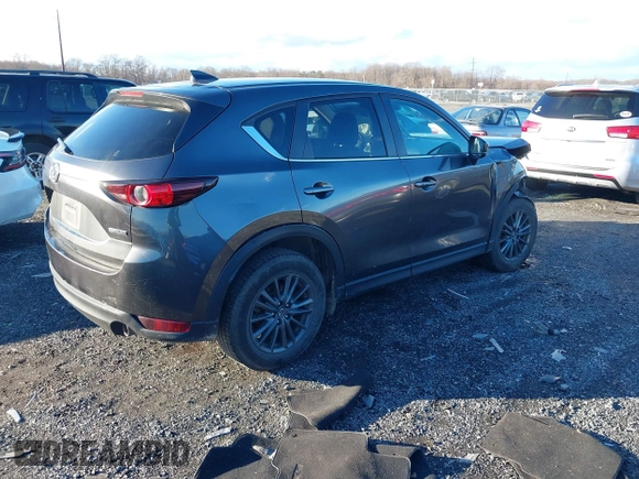 2021 Mazda CX-5 Touring with VIN JM3KFBCM8M1370640, listed as a IAAI auction lot 41207736 with 57,570 mi miles. Bid and sale history available at carsss.com. Image 4.