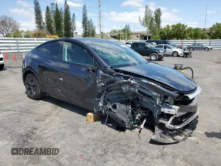 2025 Tesla Model Y Long Range with VIN 7SAYGDED8SF241779, listed as a Copart auction lot 51899205 with 12,409 mi miles and Salvage Title. Bid and sale history available at DreamBid. Image 4.