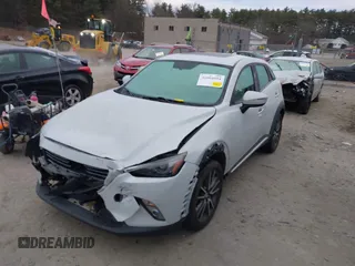 2016 Mazda CX-3 Grand Touring with VIN JM1DKFD7XG0132084, listed as a IAAI auction lot 41004954 with 70,476 mi miles. Bid and sale history available at carsss.com. Image 2.