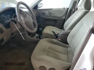 1999 Mazda Protege DX z VIN JM1BJ2224X0173126, wystawiony jako Copart lot #57389245 z przebiegiem 155 534 mil mil oraz Szkoda całkowita • Salvage title. Historia ofert i sprzedaży dostępna na DreamBid. Obrazek 7.