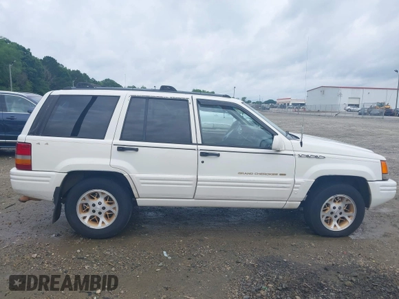 1996 Jeep Grand Cherokee Limited z VIN 1J4GZ78YXTC191527, wystawiony jako IAAI lot #42352616 z przebiegiem 325 927 mil mil oraz . Historia ofert i sprzedaży dostępna na DreamBid. Obrazek 14.