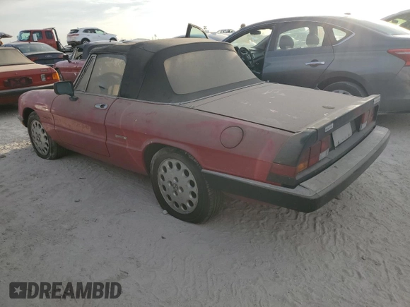 1990 Alfa Romeo Spider z VIN ZARBA12G6L6001683, wystawiony jako Copart lot #75611344 z przebiegiem 59 515 mil mil oraz Szkoda całkowita • Salvage title. Historia ofert i sprzedaży dostępna na DreamBid. Obrazek 2.