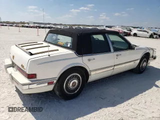 1991 Cadillac Seville z VIN 1G6KS53B9MU824142, wystawiony jako Copart lot #74276264 z przebiegiem 103 517 mil mil oraz Szkody całkowita. Historia ofert i sprzedaży dostępna na DreamBid. Obrazek 3.
