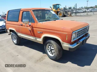 1987 Ford Bronco z VIN 1FMCU14T2HUB19762, wystawiony jako IAAI lot #42336288 z przebiegiem 78 488 mil mil oraz . Historia ofert i sprzedaży dostępna na DreamBid. Obrazek 1.