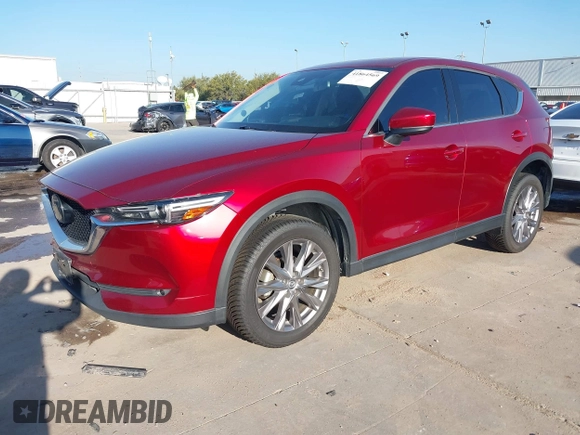 2020 Mazda CX-5 Grand Touring with VIN JM3KFADM7L0729537, listed as a IAAI auction lot 41864569 with 82,998 mi miles. Bid and sale history available at carsss.com. Image 2.