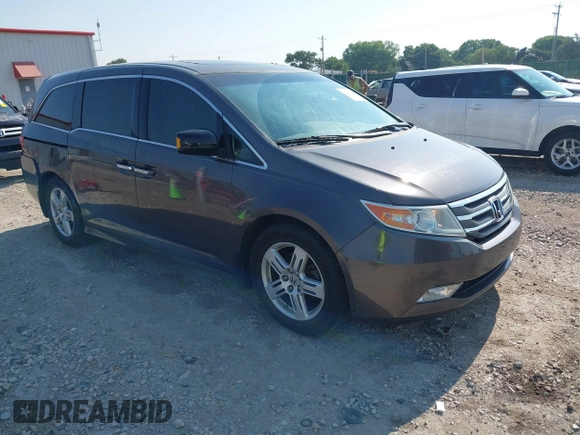 2013 Honda Odyssey Touring with VIN 5FNRL5H98DB080296, listed as a IAAI auction lot 42461843 with 104,901 mi miles and . Bid and sale history available at DreamBid. Image 1.