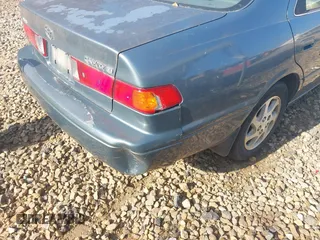 2000 Toyota Camry CE z VIN JT2BG22K5Y0476098, wystawiony jako IAAI lot #42200385 z przebiegiem Nie podano mil oraz . Historia ofert i sprzedaży dostępna na DreamBid. Obrazek 13.