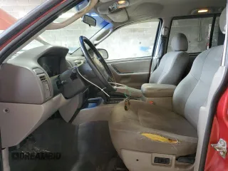 2004 Jeep Grand Cherokee Laredo with VIN 1J4GW48S04C164745, listed as a Copart auction lot 64036725 with 163,054 mi miles and Salvage title. Bid and sale history available at DreamBid. Image 7.