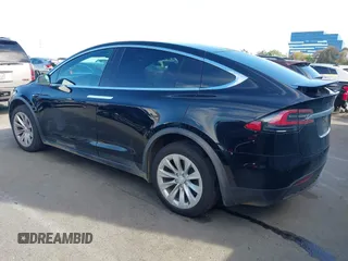 2020 Tesla Model X Long Range with VIN 5YJXCDE20LF265157, listed as a IAAI auction lot 41809572 with 58,599 mi miles. Bid and sale history available at carsss.com. Image 3.