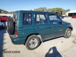 1996 Geo Tracker z VIN 2CNBE1363T6921541, wystawiony jako Copart lot #81647384 z przebiegiem 61 806 mil mil oraz Szkody całkowita. Historia ofert i sprzedaży dostępna na DreamBid. Obrazek 3.