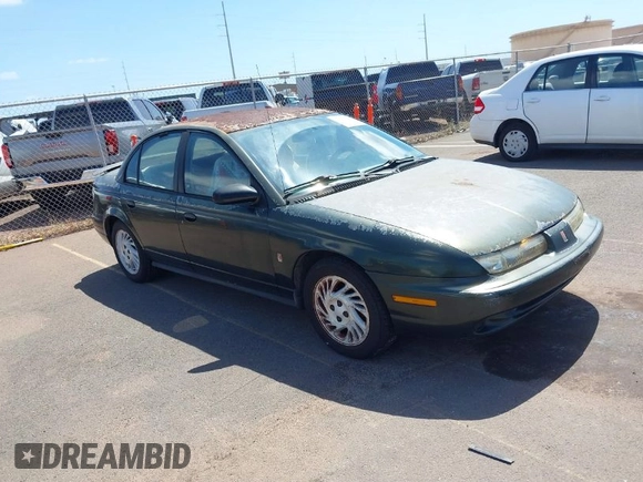 1999 Saturn SL z VIN 1G8ZK5274XZ351289, wystawiony jako IAAI lot #41734679 z przebiegiem 140 006 mil mil oraz . Historia ofert i sprzedaży dostępna na DreamBid. Obrazek 1.