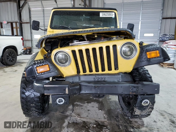 2002 Jeep Wrangler Sport z VIN 1J4FA49S02P730417, wystawiony jako Copart lot #59620865 z przebiegiem Nie podano mil oraz Szkoda całkowita • Salvage title. Historia ofert i sprzedaży dostępna na DreamBid. Obrazek 5.
