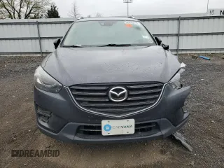2016 Mazda CX-5 Grand Touring z VIN JM3KE2DY9G0687261, wystawiony jako Copart lot #52865415 z przebiegiem Nie podano mil oraz Szkoda całkowita • Salvage title. Historia ofert i sprzedaży dostępna na DreamBid. Obrazek 5.