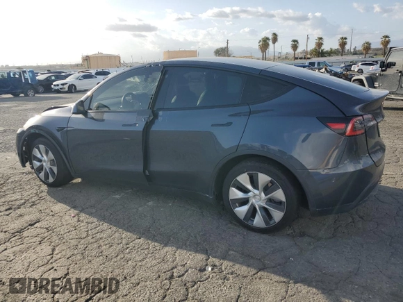 2021 Tesla Model Y Standard Range with VIN 5YJYGDED7MF109418, listed as a Copart auction lot 51590135 with 86,668 mi miles and Salvage Title. Bid and sale history available at DreamBid. Image 2.
