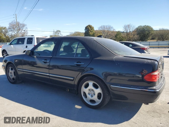 2000 Mercedes-Benz E-Class with VIN WDBJF70JXYB091085, listed as a Copart auction lot 77136484 with 185,429 mi miles and Salvage Title. Bid and sale history available at carsss.com. Image 2.