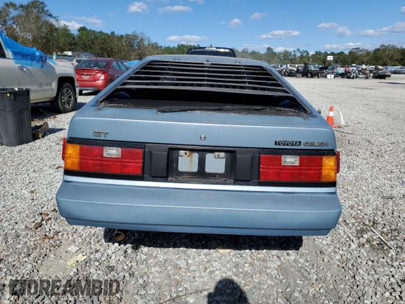 1983 Toyota Celica z VIN JT2RA64L7D6174381, wystawiony jako Copart lot #75986554 z przebiegiem 312 583 mil mil oraz Szkoda całkowita • Salvage title. Historia ofert i sprzedaży dostępna na DreamBid. Obrazek 6.