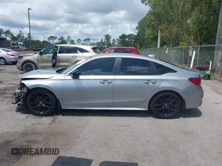 2022 Honda Civic Sport z VIN 2HGFE2F58NH586977, wystawiony jako IAAI lot #42202088 z przebiegiem 56 060 mil mil oraz . Historia ofert i sprzedaży dostępna na DreamBid. Obrazek 14.