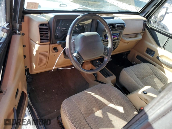 1999 Jeep Wrangler Sport with VIN 1J4FY19S6XP445867, listed as a Copart auction lot 62223125 with 146,037 mi miles and Salvage title. Bid and sale history available at DreamBid. Image 8.
