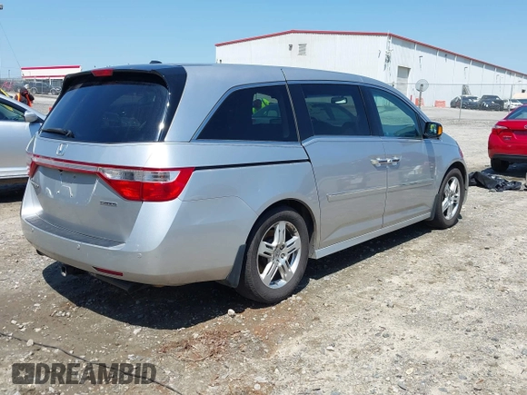 2012 Honda Odyssey Touring with VIN 5FNRL5H96CB043939, listed as a IAAI auction lot 41983643 with 202,535 mi miles. Bid and sale history available at carsss.com. Image 4.