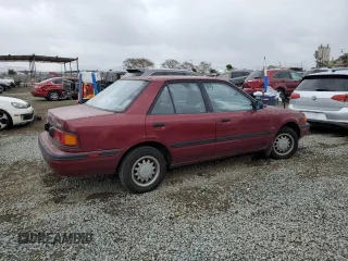 1990 Mazda Protege z VIN JM1BG2246L0167483, wystawiony jako Copart lot #48603295 z przebiegiem 170 461 mil mil oraz Czysty tytuł • Clean title. Historia ofert i sprzedaży dostępna na DreamBid. Obrazek 3.