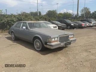 1982 Cadillac Seville z VIN 1G6AS6989CE694210, wystawiony jako Copart lot #74978254 z przebiegiem 21 412 mil mil oraz Tytuł czysty. Historia ofert i sprzedaży dostępna na DreamBid. Obrazek 1.