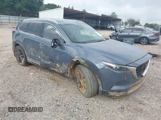 2021 Mazda CX-9 Grand Touring with VIN JM3TCADY2M0509286, listed as a IAAI auction lot 39976279 with 93,588 mi miles and . Bid and sale history available at DreamBid. Image 1.