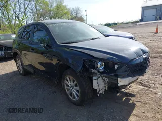 2014 Mazda CX-5 Touring z VIN JM3KE4CY4E0328880, wystawiony jako IAAI lot #42112302 z przebiegiem 185 228 mil mil oraz . Historia ofert i sprzedaży dostępna na DreamBid. Obrazek 1.