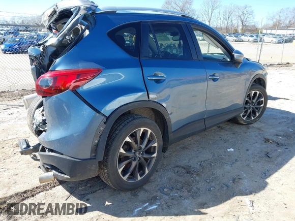 2016 Mazda CX-5 Grand Touring with VIN JM3KE2DY2G0715272, listed as a IAAI auction lot 41590492 with 134,176 mi miles. Bid and sale history available at carsss.com. Image 4.