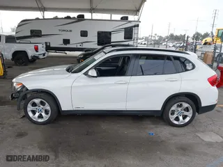 2015 BMW X1 sDrive28i with VIN WBAVM1C53FV318663, listed as a IAAI auction lot 41711526 with 182,204 mi miles. Bid and sale history available at carsss.com. Image 14.