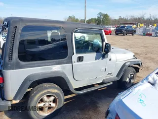 2004 Jeep Wrangler Sport Right Hand Drive with VIN 1J4F449SX4P780560, listed as a IAAI auction lot 41645721 with 146,681 mi miles. Bid and sale history available at carsss.com. Image 14.