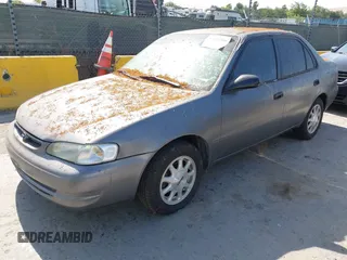 1999 Toyota Corolla VE z VIN 1NXBR12E5XZ237045, wystawiony jako IAAI lot #42413586 z przebiegiem Nie podano mil oraz . Historia ofert i sprzedaży dostępna na DreamBid. Obrazek 2.