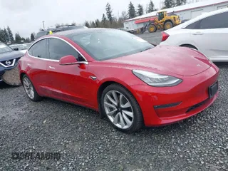 2018 Tesla Model 3 Long Range Battery z VIN 5YJ3E1EB2JF087823, wystawiony jako IAAI lot #41903609 z przebiegiem 69 749 mil mil oraz . Historia ofert i sprzedaży dostępna na DreamBid. Obrazek 1.