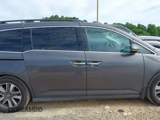 2015 Honda Odyssey Touring Elite z VIN 5FNRL5H97FB060981, wystawiony jako IAAI lot #42289631 z przebiegiem 160 947 mil mil oraz . Historia ofert i sprzedaży dostępna na DreamBid. Obrazek 13.