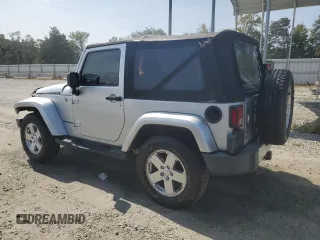 2009 Jeep Wrangler Sahara with VIN 1J4FA54119L747068, listed as a Copart auction lot 71209904 with 86,978 mi miles and Salvage title. Bid and sale history available at DreamBid. Image 2.