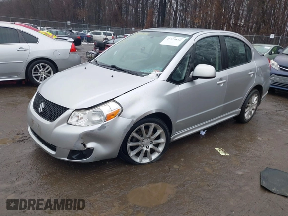 2011 Suzuki SX4 z VIN JS2YC5A41B6300385, wystawiony jako IAAI lot #41570810 z przebiegiem 117 847 mil mil oraz . Historia ofert i sprzedaży dostępna na DreamBid. Obrazek 2.