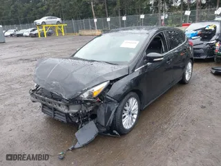 2015 Ford Focus Titanium with VIN 1FADP3N2XFL300859, listed as a IAAI auction lot 41944410 with 76,194 mi miles. Bid and sale history available at carsss.com. Image 2.