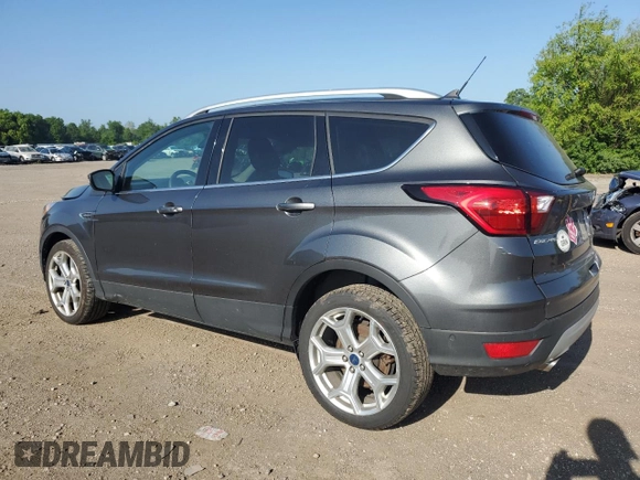 2019 Ford Escape Titanium with VIN 1FMCU0J96KUB22884, listed as a Copart auction lot 61979665 with 63,824 mi miles and Salvage title. Bid and sale history available at DreamBid. Image 2.
