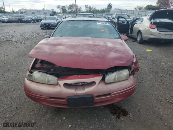 1996 Ford Thunderbird LX with VIN 1FALP62W7TH135632, listed as a Copart auction lot 77134024 with 128,931 mi miles and Salvage Title. Bid and sale history available at carsss.com. Image 5.