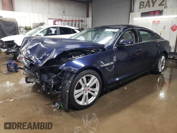 2014 Jaguar XJ Portfolio with VIN SAJWJ2GD5E8V69562, listed as a Copart auction lot 87737195 with 100,525 mi miles and Salvage title. Bid and sale history available at DreamBid. Image 1.