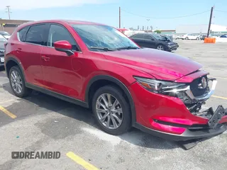 2021 Mazda CX-5 Grand Touring with VIN JM3KFADM6M1373111, listed as a IAAI auction lot 42784431 with 14,374 mi miles and . Bid and sale history available at DreamBid. Image 1.